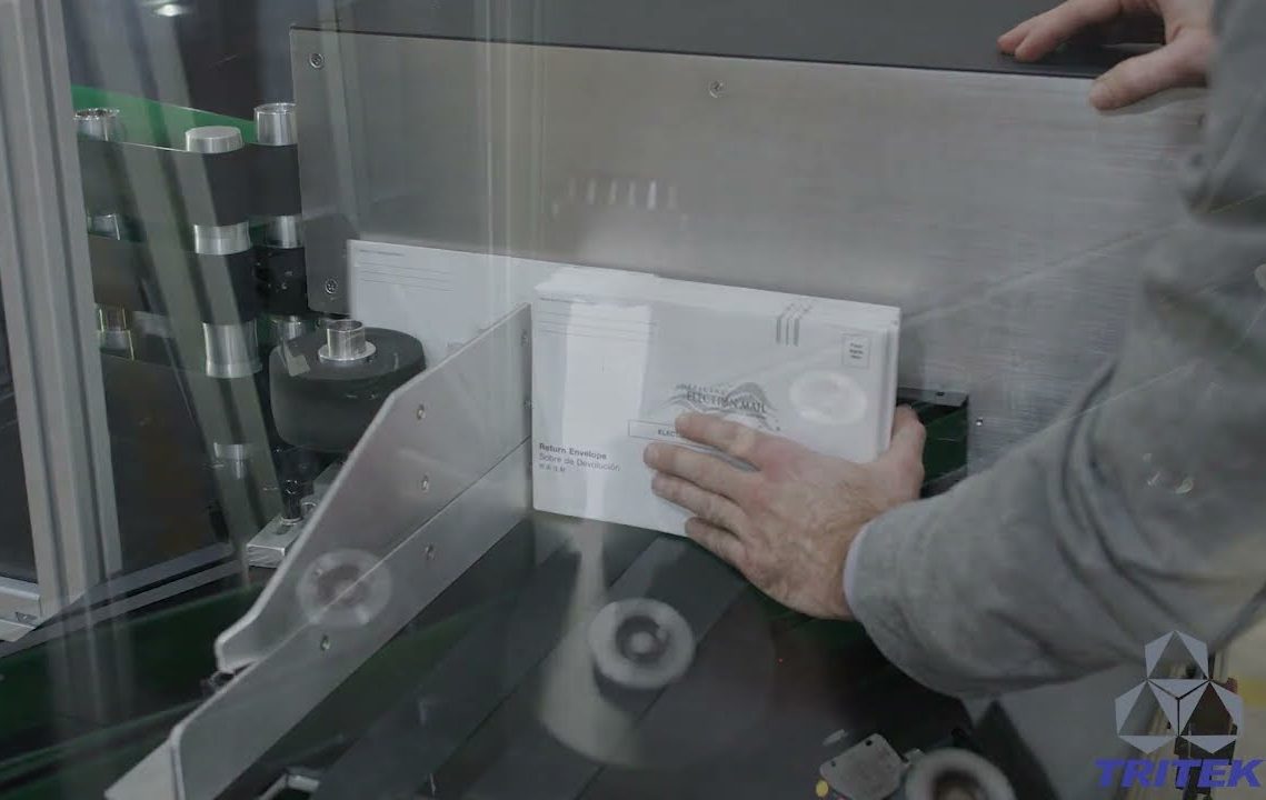 Inserting absentee ballots into a processing system